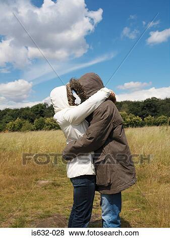 Couple in parkas hugging View Large Photo Image Stock Photo - Couple in parkas hugging. Fotosearch