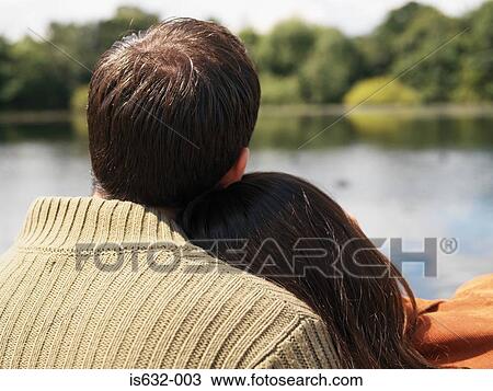 Couple sitting near lake View Large Photo Image Stock Image - Couple sitting near lake. Fotosearch