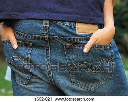 Stock Image - Couple with hands in back pockets. Fotosearch