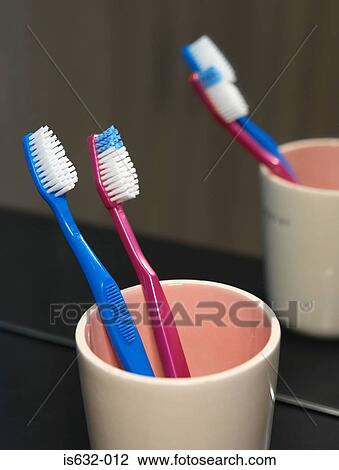 Stock Image - Toothbrushes in mug. Fotosearch