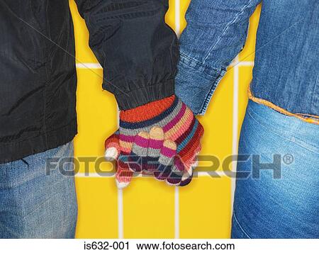 Stock Image - Young couple holding hands. Fotosearch