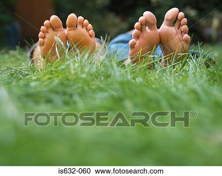 Young couple relaxing in field View Large Photo Image Stock Image - Young couple relaxing in field. Fotosearch