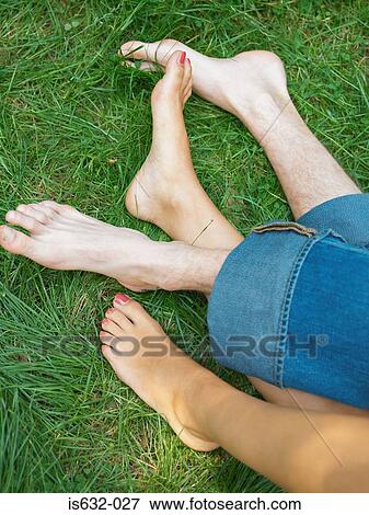 Young couple relaxing on grass View Large Photo Image Stock Photo - Young couple relaxing on grass. Fotosearch