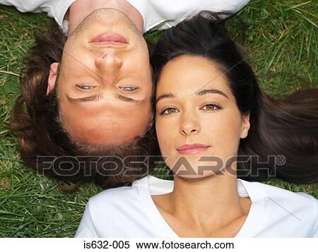 Young couple resting on grass View Large Photo Image Stock Photography - Young couple resting on grass. Fotosearch