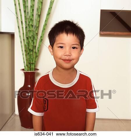 Boy standing near houseplant View Large Photo Image Stock Image - Boy standing near houseplant. Fotosearch