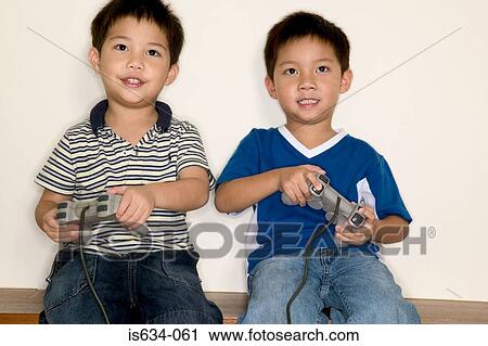 Boys playing video game View Large Photo Image Stock Image - Boys playing video game. Fotosearch