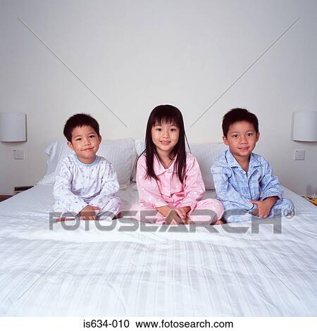 Children on bed smiling View Large Photo Image Stock Image - Children on bed smiling. Fotosearch