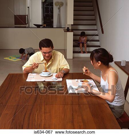 Family eating a meal View Large Photo Image Stock Photo - Family eating a meal. Fotosearch