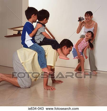 Stock Image - Family playing at home. Fotosearch