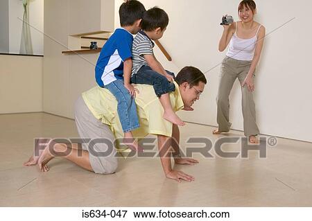 Stock Photo - Family playing at home. Fotosearch