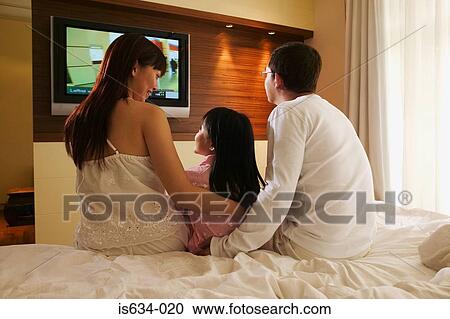 Family watching television View Large Photo Image Stock Image - Family watching television. Fotosearch