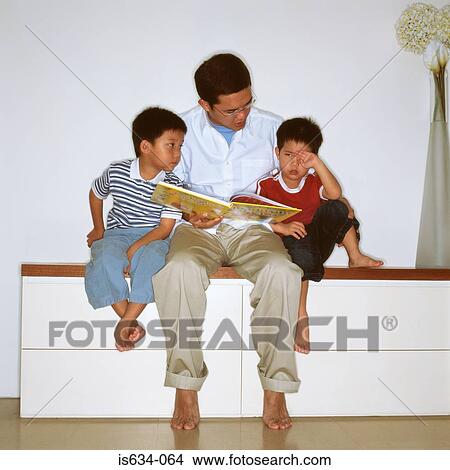 Father reading with sons View Large Photo Image Picture - Father reading with sons. Fotosearch