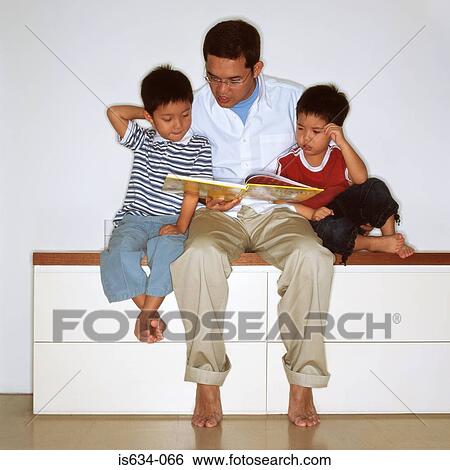 Father reading with sons View Large Photo Image Stock Photograph - Father reading with sons. Fotosearch
