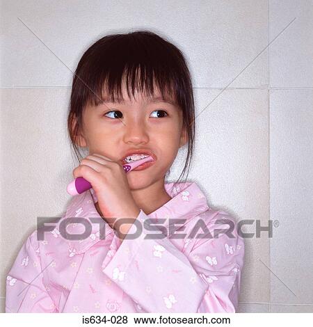 Stock Photo - Girl brushing her teeth. Fotosearch