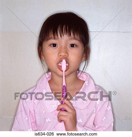 Girl brushing her teeth View Large Photo Image Stock Photograph - Girl brushing her teeth. Fotosearch