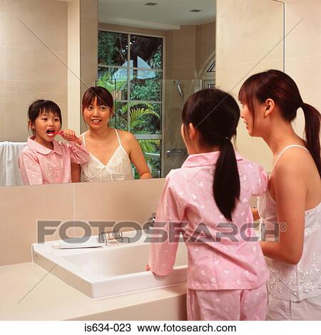Mother and daughter brushing their teeth View Large Photo Image Stock Image - Mother and daughter brushing their teeth. Fotosearch