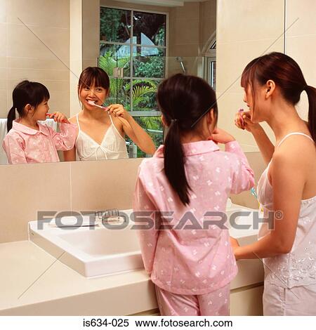 Mother and daughter brushing their teeth View Large Photo Image Stock Photography - Mother and daughter brushing their teeth. Fotosearch