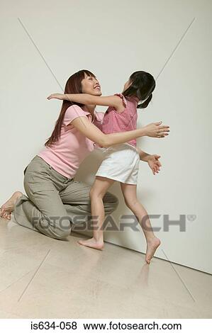 Mother hugging her daughter View Large Photo Image Stock Photo - Mother hugging her daughter. Fotosearch