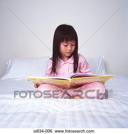 Young girl reading on bed View Large Photo Image Stock Photograph - Young girl reading on bed. Fotosearch