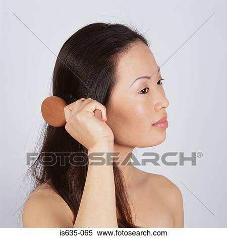 Asian woman brushing hair View Large Photo Image Stock Photography - Asian woman brushing hair. Fotosearch