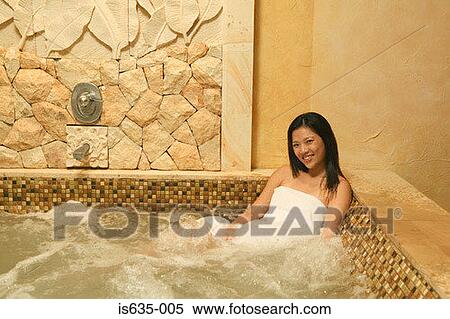 Stock Photography - Smiling woman in hot tub. Fotosearch