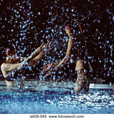 Two women playing in swimming pool View Large Photo Image Stock Photography - Two women playing in swimming pool. Fotosearch