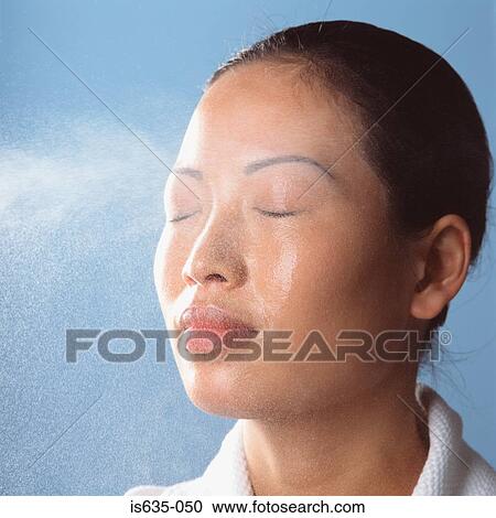 Water spraying on womans face View Large Photo Image Stock Image - Water spraying on womans face. Fotosearch