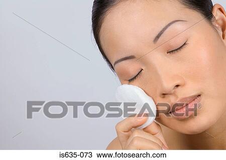 Woman applying make-up with cotton pad View Large Photo Image Stock Image - Woman applying make-up with cotton pad. Fotosearch