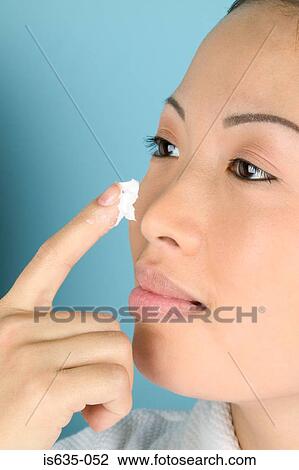 Woman applying moisturiser to cheek View Large Photo Image Stock Image - Woman applying moisturiser to cheek. Fotosearch