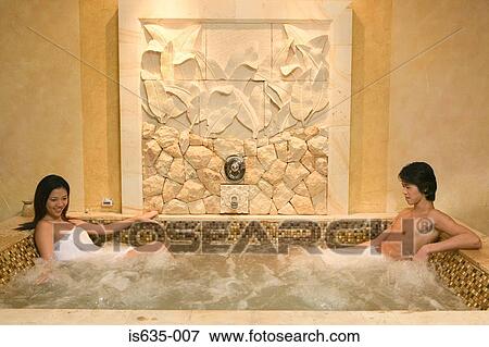 Young couple relaxing in hot tub View Large Photo Image Stock Photo - Young couple relaxing in hot tub. Fotosearch