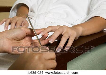 Young woman having a manicure View Large Photo Image Picture - Young woman having a manicure. Fotosearch