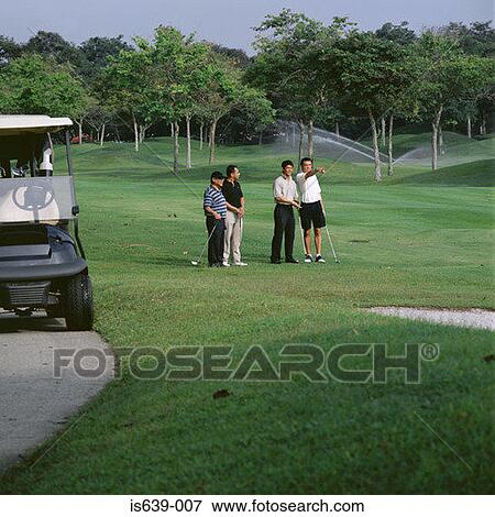 Four men playing golf View Large Photo Image Stock Photo - Four men playing golf. Fotosearch