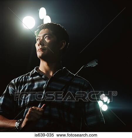 Man on driving range at night View Large Photo Image Stock Photography - Man on driving range at night. Fotosearch