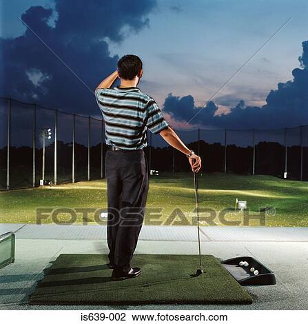 Man practising on driving range View Large Photo Image Stock Image - Man practising on driving range. Fotosearch