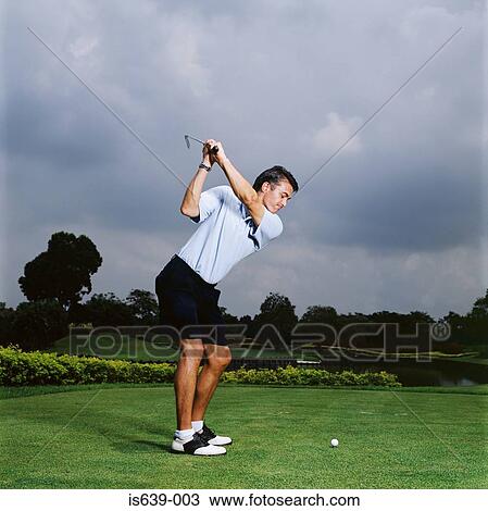 Man swinging golf club View Large Photo Image Stock Image - Man swinging golf club. Fotosearch