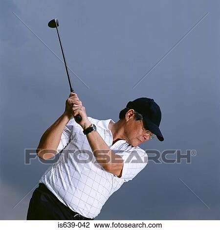 Man Swinging Golf Club Stock Image