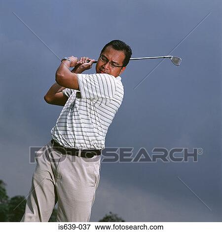 Man swinging golf club View Large Photo Image Stock Photo - Man swinging golf club. Fotosearch