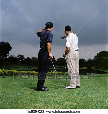 Two men playing golf View Large Photo Image Stock Image - Two men playing golf. Fotosearch