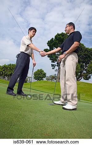 Two men playing golf View Large Photo Image Stock Image - Two men playing golf. Fotosearch