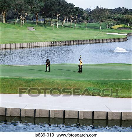 Stock Photo - Two men playing golf. Fotosearch
