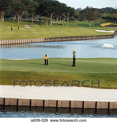 Two men playing golf View Large Photo Image Stock Photo - Two men playing golf. Fotosearch