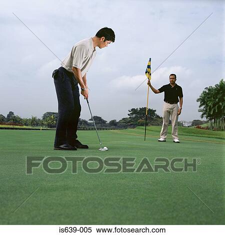 Stock Photography - Two men playing golf. Fotosearch