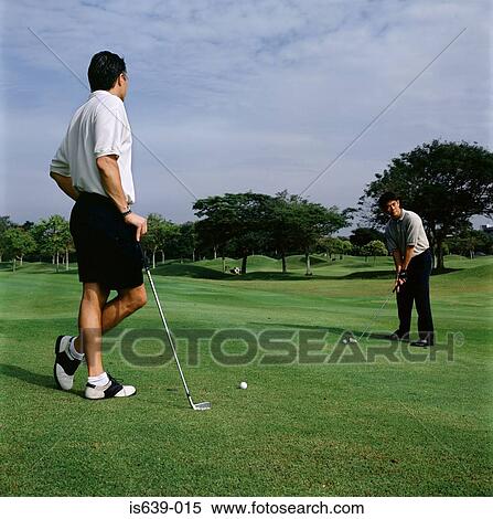Two men playing golf View Large Photo Image Stock Photography - Two men playing golf. Fotosearch