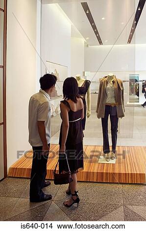 Couple looking in clothes store window View Large Photo Image Picture - Couple looking in clothes store window. Fotosearch