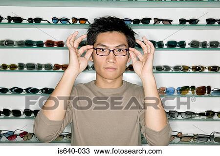 Man shopping for eyeglasses View Large Photo Image Stock Image - Man shopping for eyeglasses. Fotosearch