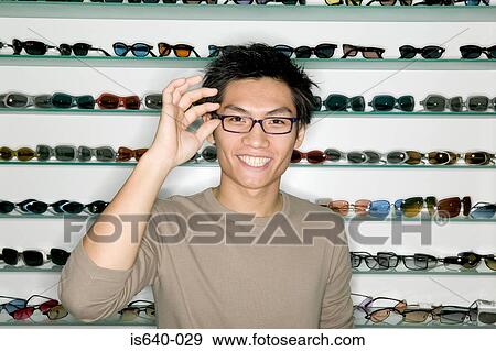 Stock Photo - Man shopping for eyeglasses. Fotosearch