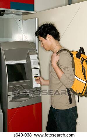 Man using a cash machine View Large Photo Image Stock Photo - Man using a cash machine. Fotosearch