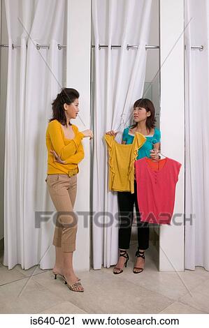 Two women in clothes store View Large Photo Image Stock Image - Two women in clothes store. Fotosearch