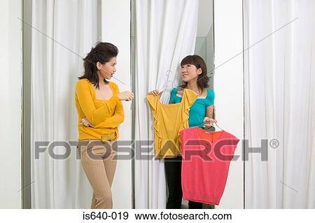 Two women in clothes store View Large Photo Image Stock Photo - Two women in clothes store. Fotosearch