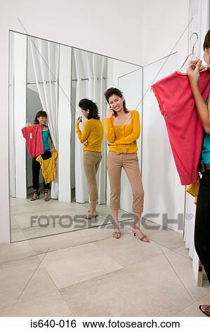 Stock Photograph - Two women in clothes store. Fotosearch